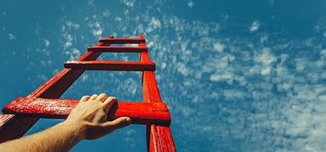 hand climbing ladder into the sky